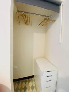 a closet with a white cabinet and a drawer at Il fiore Blue in Barletta