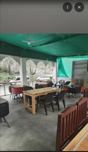 a group of tables and chairs under a green tent at Apricot Cafe and Restaurant Shapa in Turtuk