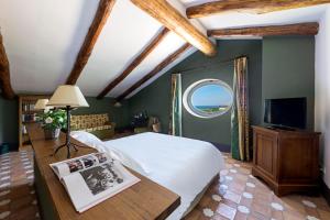 a bedroom with a large bed and a window at Relais Regina Giovanna in Sorrento