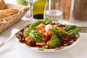 a plate of food with a salad on a table at Relais Regina Giovanna in Sorrento