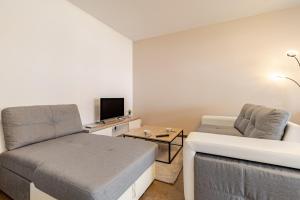 a living room with a bed and a couch at Le Cocon de Beaumont - T3 Cozy in Beaumont