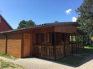 a large wooden building with a garage at Cozy Getaway House in Šventoji