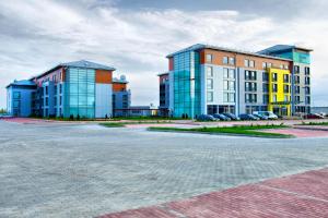 a group of buildings in a parking lot at Hotel Ambassador Kaluga in Kaluga