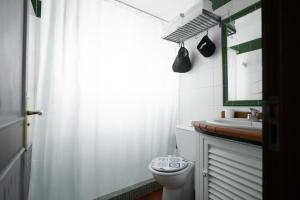 a white bathroom with a toilet and a sink at Marody House Vacacional in Granadilla de Abona +70 photos