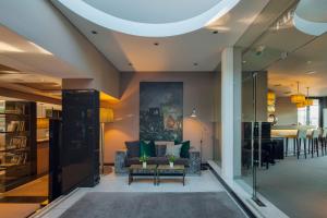 a living room with a couch and a table at Cidnay - Hotel & Executive Center in Santo Tirso