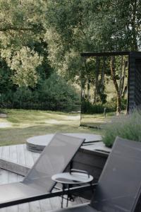 a patio with a table and two stools and a grill at Watermill Resort in Leebiku