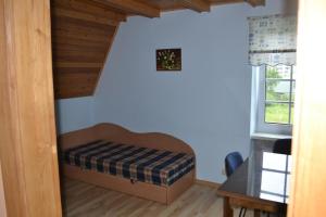 a small bedroom with a bed in a room at Apartamentai Vanagupės rajone in Palanga