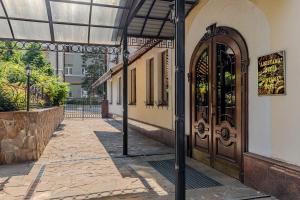 a building with a large door on a street at Gallery Hotel Gintama in Kyiv