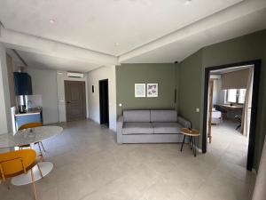 a living room with a couch and a table at Chanioporta suites in Heraklio