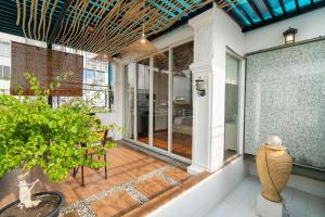 an indoor patio with glass doors and a plant at V Living - Airport Stopover with Free Laundry in Ho Chi Minh City +92 photos