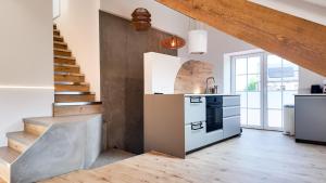 a kitchen with a staircase and a kitchen with a stove at El Sart in Sart-lez-Spa