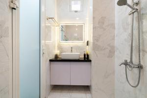 a white bathroom with a sink and a shower at V Living Lam Sơn in Ho Chi Minh City +58 photos