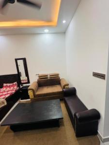 a living room with a couch and a table at Bansal Studio in Noida