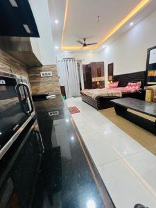 a large living room with a bed and a living room at Bansal Studio in Noida