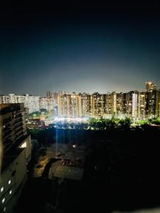 a view of a city at night with buildings at Bansal Studio in Noida