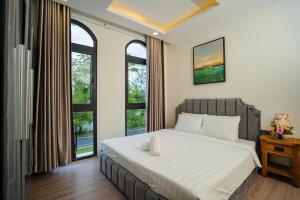 Postel nebo postele na pokoji v ubytování LA Homestay - Lá's House