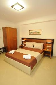 Postel nebo postele na pokoji v ubytování Philippeio Hotel