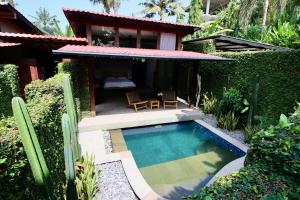 a small swimming pool in front of a house at Balian Surf and Sand in Balian