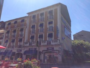 a large building with balconies on the side of it at Hôtel Océan in Lourdes