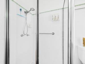 a shower with a glass door in a bathroom at Beachfront Escape Relaxing Getaway in Batehaven in Sunshine Bay +29 photos