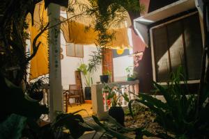 a room with a bunch of plants and a tv at Low budget double room in Paje in Paje