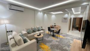 a living room with a couch and a table at فندق رافيليا - أحد رفيده Rafellia Hotel in Ahad Rafidah