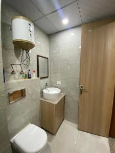 a bathroom with a toilet and a sink at Kaveri City Center in Greater Noida
