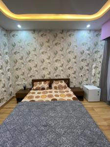 a bedroom with a bed and a wall mural at Kaveri City Center in Greater Noida