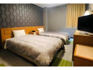 Giường trong phòng chung tại Urban Place Inn Kokura +53 ảnh