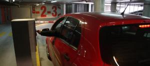 a red car is parked in a parking garage at Cowshed w Floor Heating in Ugly Duckling Courtyard in Zagreb