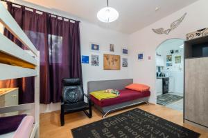 a small bedroom with a bed and a chair at Apartment Senka in Zagreb
