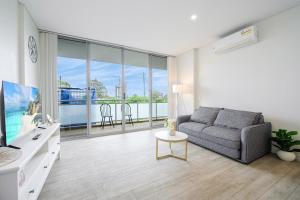 a living room with a couch and a large window at Liverpool 3Br APT Business Hospital Parking 8ppl in Liverpool