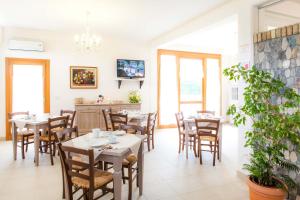 a dining room with tables and chairs and a tv at Agriturismo la Chiocciola in Sacile
