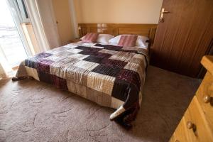 a bedroom with a bed with a quilt on it at Apartment Grande Vista in Starigrad Paklenica with a large terrace in Starigrad-Paklenica