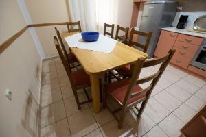 a kitchen with a wooden table with a bowl on it at Apartment Grande Vista in Starigrad Paklenica with a large terrace in Starigrad-Paklenica