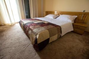 a bedroom with a large bed with a quilt on it at Apartment Grande Vista in Starigrad Paklenica with a large terrace in Starigrad-Paklenica