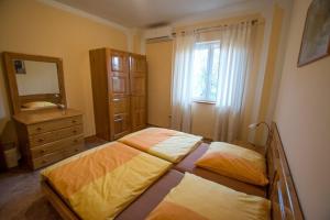 a bedroom with two beds and a dresser and a mirror at Apartment Grande Vista in Starigrad Paklenica with a large terrace in Starigrad-Paklenica +70 photos