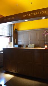 a reception counter at a restaurant with a sign that reads satisfaction at Alexander Inn in Philadelphia