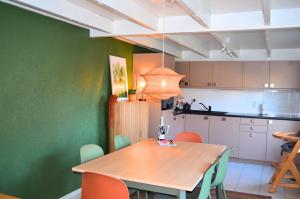a kitchen and dining room with a wooden table and chairs at Vakantiewoning in De Haan - Beachhouse68 in De Haan