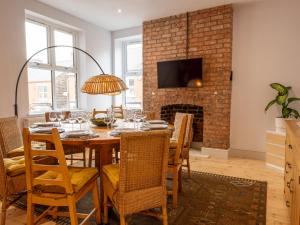 a dining room with a table and chairs and a fireplace at 33 Lorne Street in Chester