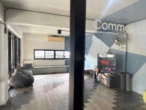 a room with a living room with a couch and a room with at The August Hostel in Chiang Mai