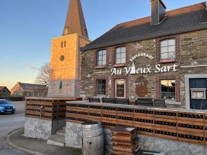 an old versus salt restaurant with a tower on a street at El Sart in Sart-lez-Spa