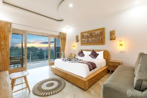 a bedroom with a bed and a couch at Kaylas Hill in Nusa Penida
