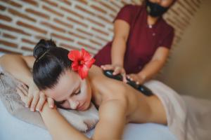a woman sitting on a bed getting her hair cut at Terra Apartments in Caesar Blue Resort, Gym, Aquapark, Swimming pools, Sauna, Kids club in Kalecik +104 photos