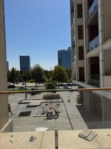 a view of a courtyard of a building with benches at Tashkent City Gardens Residence D11-4-27 in Tashkent