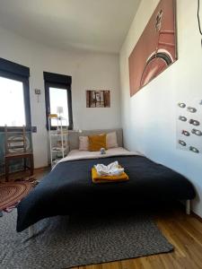 a bedroom with a large bed with a black blanket at Central Artsy Studio, self check-in! in Bucharest