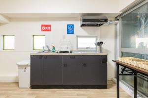 a kitchen with a sink and a counter top at 東新宿1007 Good location within 15 minutes of Shinjuku Station in Tokyo