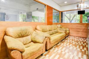 a living room with a couch and a television at Super Collection O Balewadi formerly Woods Regency in Pune