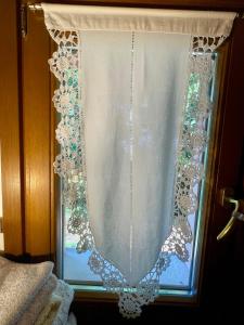 a window with a white curtain on it at La casa nel parco in Mogliano Veneto +43 photos