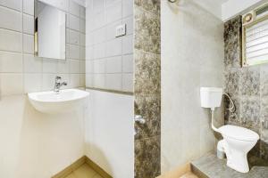 a bathroom with a toilet and a sink at Super Collection O Balewadi formerly Woods Regency in Pune